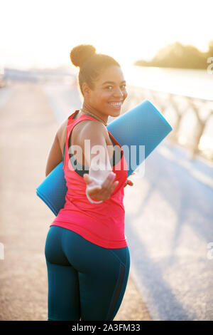 Plump woman working on weight loss walking to yoga Stock Photo