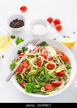 vegan ketogenic spiralized courgette salad with avocado tomato pumpkin seeds Stock Photo
