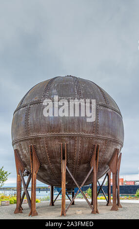 Round Rusty Tank with Rivets on Coast Stock Photo - Alamy