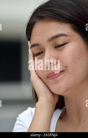 A Tired Filipina Female Woman Stock Photo