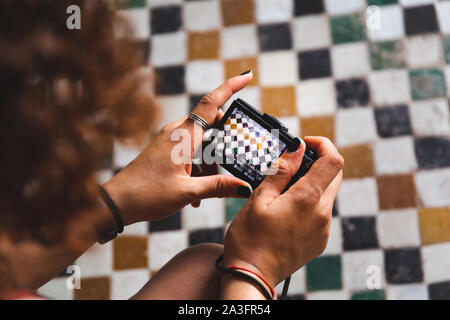 close up of woman's hands holding point and shoot camera photographing moroccan mosaic - travel photography - leisure activities - Marrakesh, Morocco Stock Photo