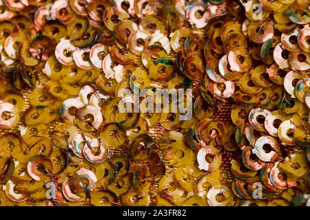 A cloth with yellow sequins in a close up view Stock Photo