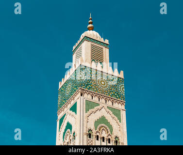low angle view of Hassan II mosque's minaret in the middle of the day Stock Photo