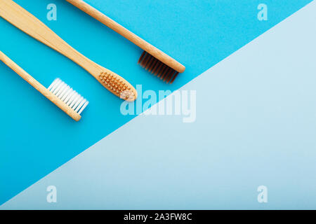 Dental care with eco friendly bamboo toothbrush on blue background top view. Zero waste and plastic free concept. Stock Photo