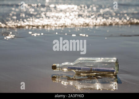 bottle with a message on the beach Stock Photo