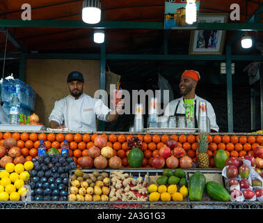 Marrakech, Morocco - 15 JAN 2019: Two happy arabic Fruit fresh juice sellers on Jemma El Fna square in Marrakesh, Morocco