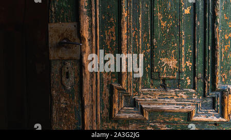 Closeup on open, old, wooden, green door with fixed vintage door handle Stock Photo