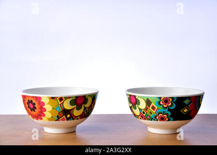 Colorful bowls on the table on white background. Stock Photo