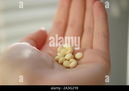 many pills in human hand, close up. Stock Photo