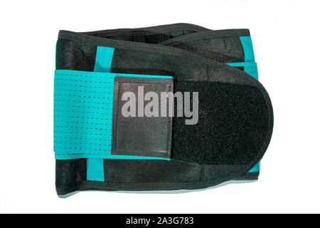 Close up of black medical waist belt for back pain isolated on white background. Top view. Stock Photo