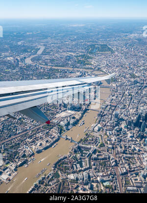 View from plane window over River Thames & city centre, with The Shard, Tower bridge and Hyde Park, London, England, UK Stock Photo