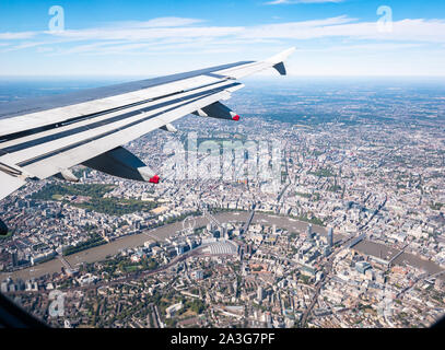 View from plane window over River Thames & Westminster: London Eye, St James Park, Regent's Park & Waterloo station, London, England, UK Stock Photo