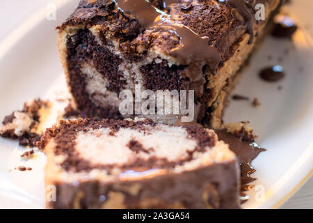 Marble chocolate cake served with chocolate sauce Stock Photo