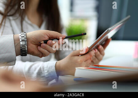 Two architects discussing drawing together using tablet pc Stock Photo