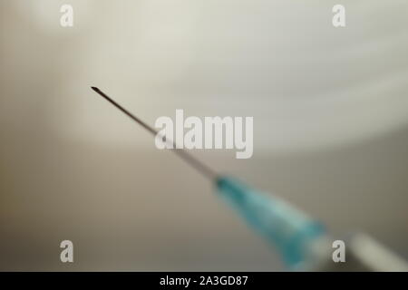new syringe with focus on the needle, side view, selective focus Stock Photo
