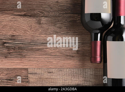 Top view of two wine bottles with blank labels on a rustic wood table with copy space. Stock Photo