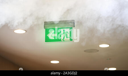 Evacuating sign in office builging while fire Stock Photo