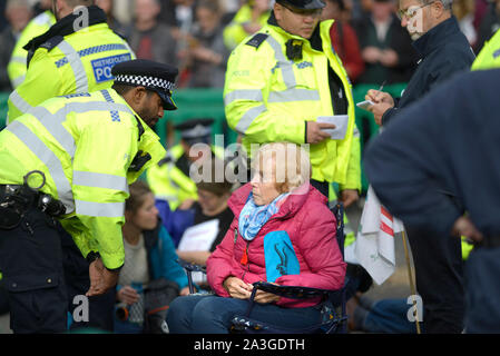 London, UK. 8th October 2019. Extinction Rebellion protests bring central London to a standstill for a second day. People of all ages take part in a sit down protest in Parliament Square Credit: PjrFoto/Alamy Live News Stock Photo