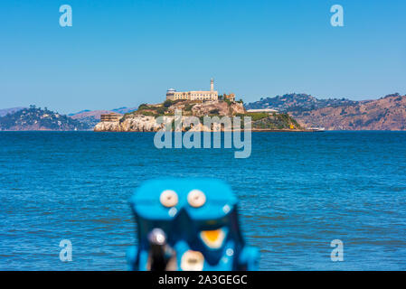 Alcatraz Island and former prison in San Francisco Bay, California, USA. Out of focus binoculars on foreground. Stock Photo