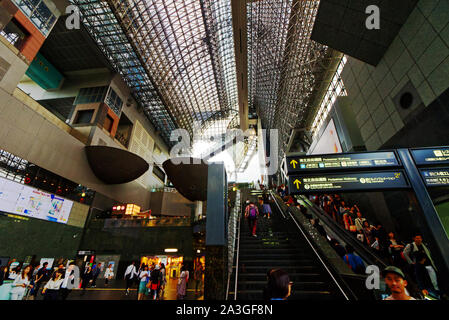 Rush hour crowds in the futuristic main hall of Kyoto Station, Japan Stock Photo