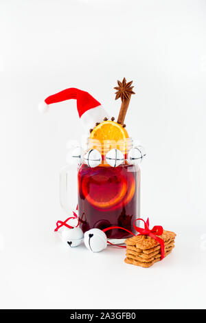 Mulled wine in a mason jar and german gingerbread on white background. Stock Photo