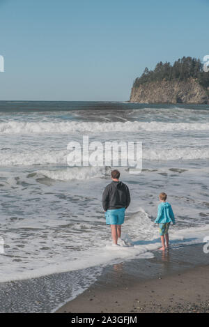 Man and son playing in the ocean Stock Photo