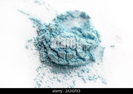 Loose turquoise eye shadow powder, isolated on white background. Stock Photo
