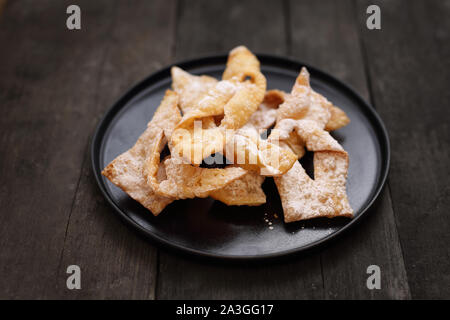 Fat Thursday. Traditional shortbread sweets with powdered sugar. Stock Photo