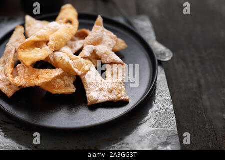 Angel wings.Traditional shortbread crepes with powdered sugar, regional carnival sweets. Stock Photo