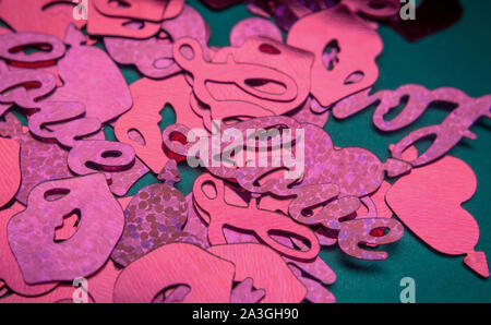 Valentine's day festive background. Dark red hearts, words "Love" and lips made of glitter Stock Photo