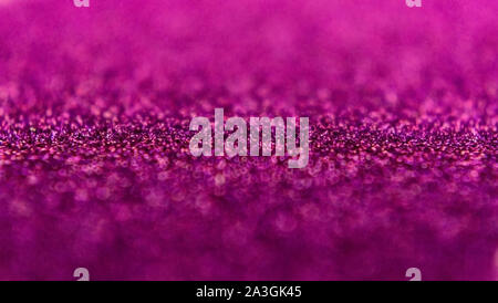 Glitter background in pink / purple / magenta color. Festive background. Small size particles. Magic glowing effect. Perfect for phone wallpaper, fest Stock Photo