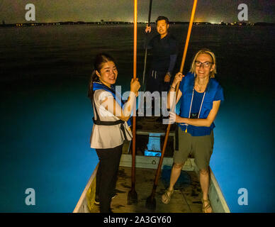 Takiya-ryo spearfishing on lake Hanama, Hamamatsu, Japan. Spear and prop in one. The mori also helps the hunter keep his balance on the boat. Here reporter Angela Berg together with Momoko Takii from TSJ. Stock Photo