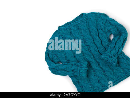 Flat lay top view turquoise cozy knit sweater on white background Stock Photo