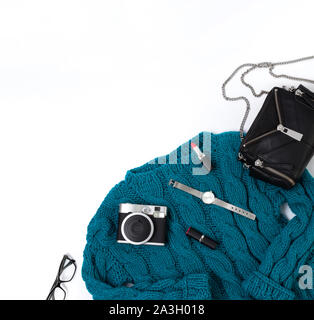 Flat lay top view female casual style look with warm turquoise sweater, jeans, watch, glasses and purse Stock Photo