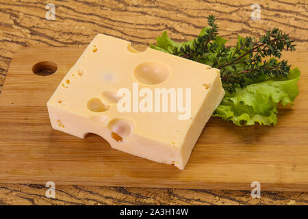 Maasdam cheese brick with thyme branch Stock Photo