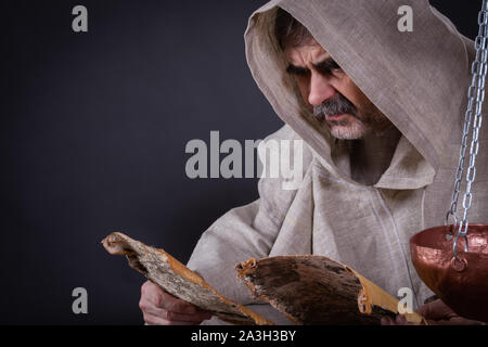 Monk with an ancient bible manuscript in a monastery museum, Zege ...