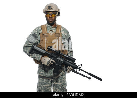 American male soldier serve in army, hears and executes orders, looking at camera. Soldier wearing uniform, armour and helmet with modern weapon. White isolated studio background. Stock Photo