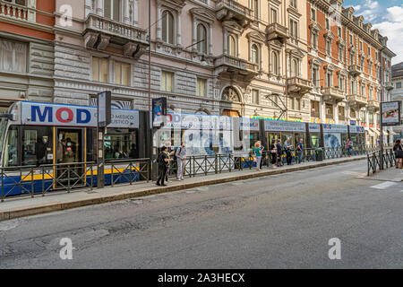 P{people waiting at a at bus and tram  stop along Via Antonio Bertola in Turin,Italy Stock Photo