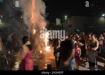 Smoke rises from a Holi bonfire at a housing complex in Mumbai, India. With the high number of celebrations in India, smoke pollution is on the rise. Stock Photo