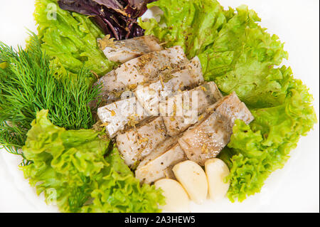 Salted herring fish with onions, herbs, spices on a white background Stock Photo
