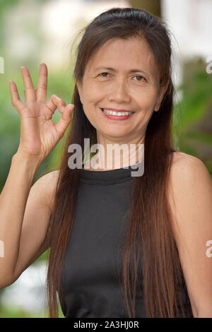 Older Filipina Female Senior And Okay Sign Stock Photo - Alamy