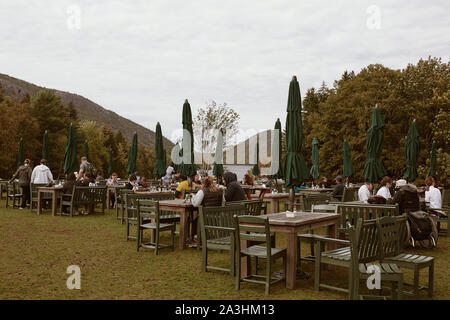 Mount Desert Island, Maine - September 28th, 2019:  Tables and chairs overlooking Jordan Pond at Jordan Pond House restaurant in Acadia National Park Stock Photo