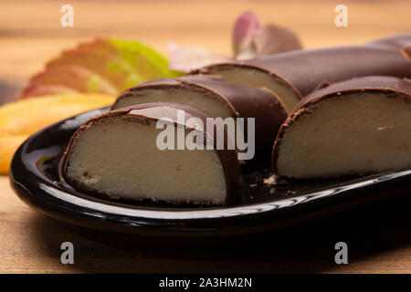 Dutch chocolate candy filled with white marzipan  in autumn colors on dark wooden background close up Stock Photo
