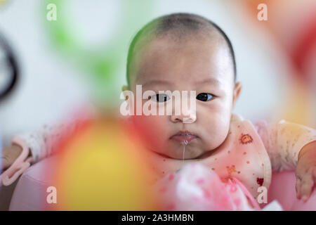 Little 4 months baby boy playing with toys at sweet home Stock Photo