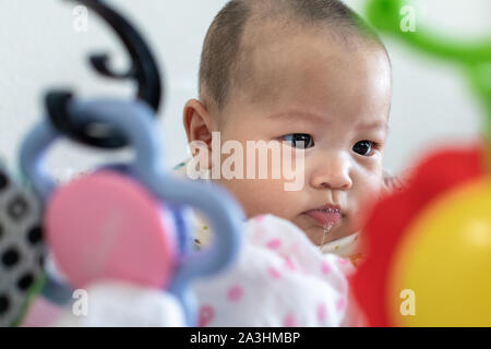 Little 4 months baby boy playing with toys at sweet home Stock Photo