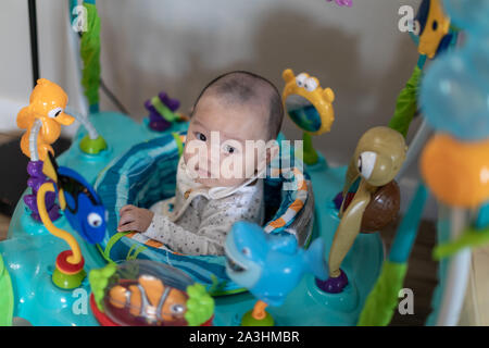 Little 4 months baby boy playing with toys at sweet home Stock Photo