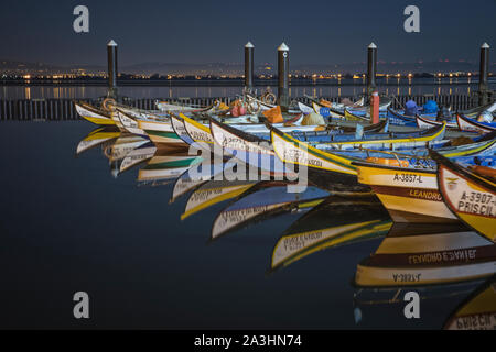 wooden boats reflected in the port of Aveiro Stock Photo