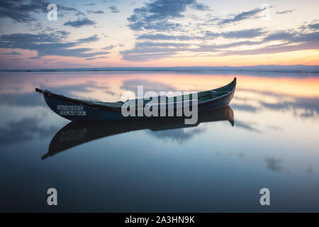 wooden boat at sunrise Stock Photo