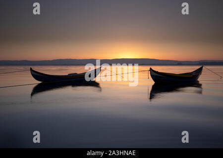 two wooden boats at sunrise Stock Photo