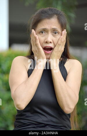 Surprised Retired Asian Female Senior Grandmother Stock Photo
